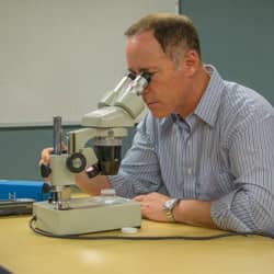 A man looking into a microscope