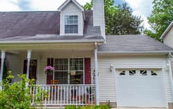White home with porch.