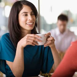 Woman having Pumpkin-spiced latte with a friend.