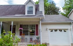 White home with porch.